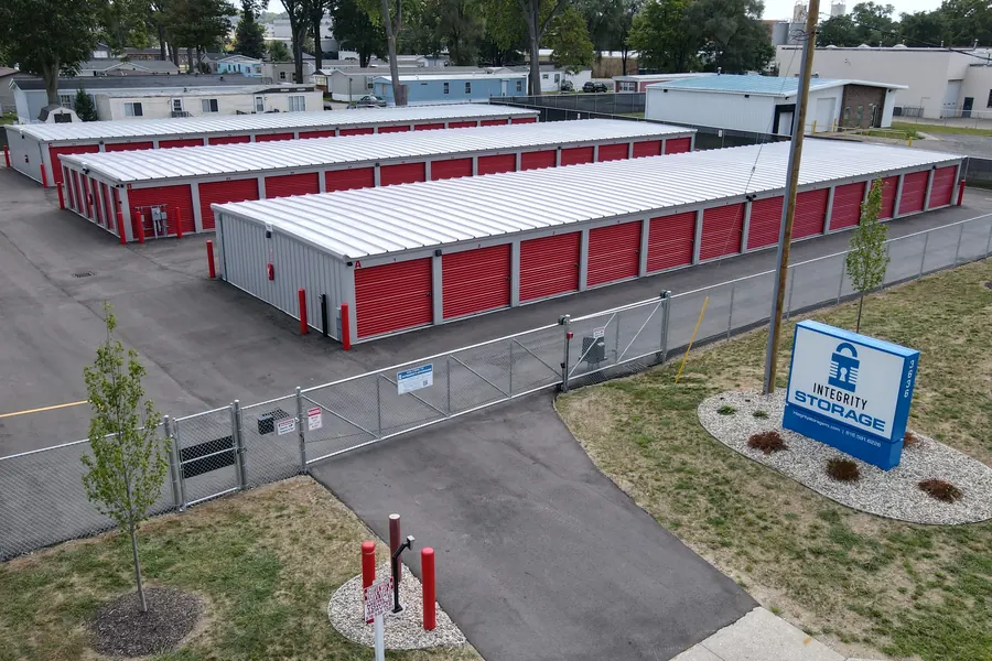 Integrity Storage from above: fenced lot with red roll-up door units on the south side of Grand Rapids