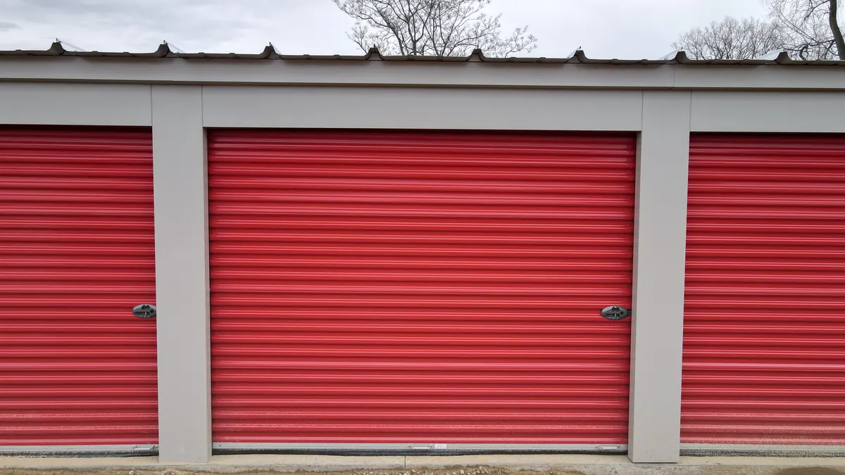 Red roll-up doors on drive-up storage units at Integrity Storage, near Kentwood